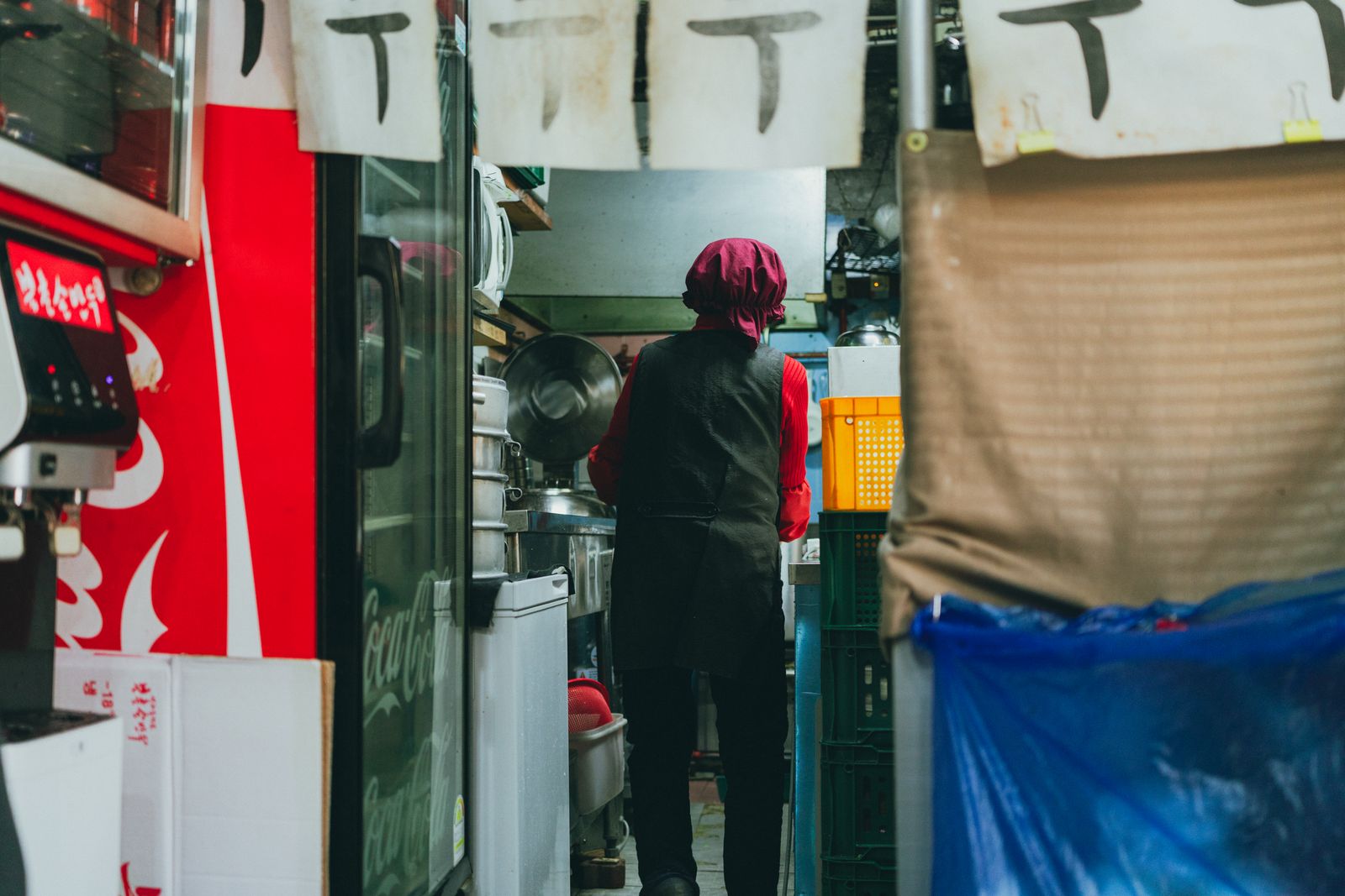 A chef working inside a Seoul street-food counter.