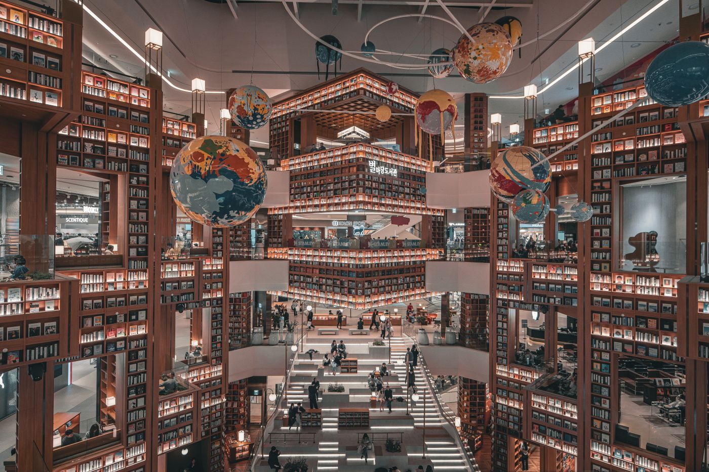A Seoul library interior with tall bookshelves and open public space, showing the visual side of Korea's focus culture.