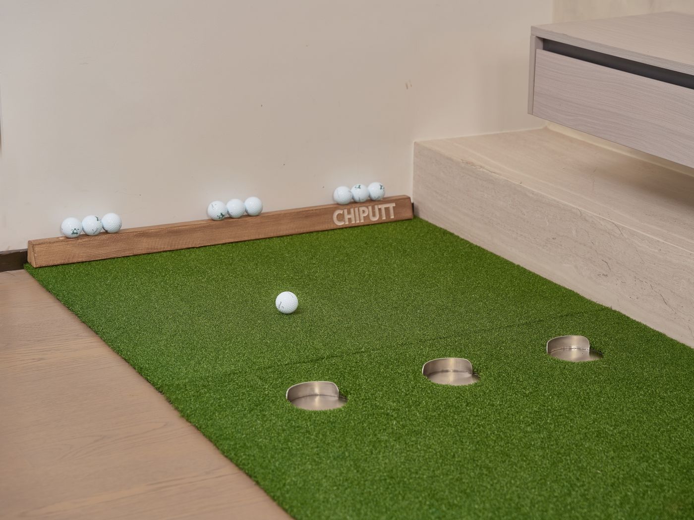 Indoor putting equipment and golf balls, a safe visual stand-in for the training side of Korea's screen-golf habit.