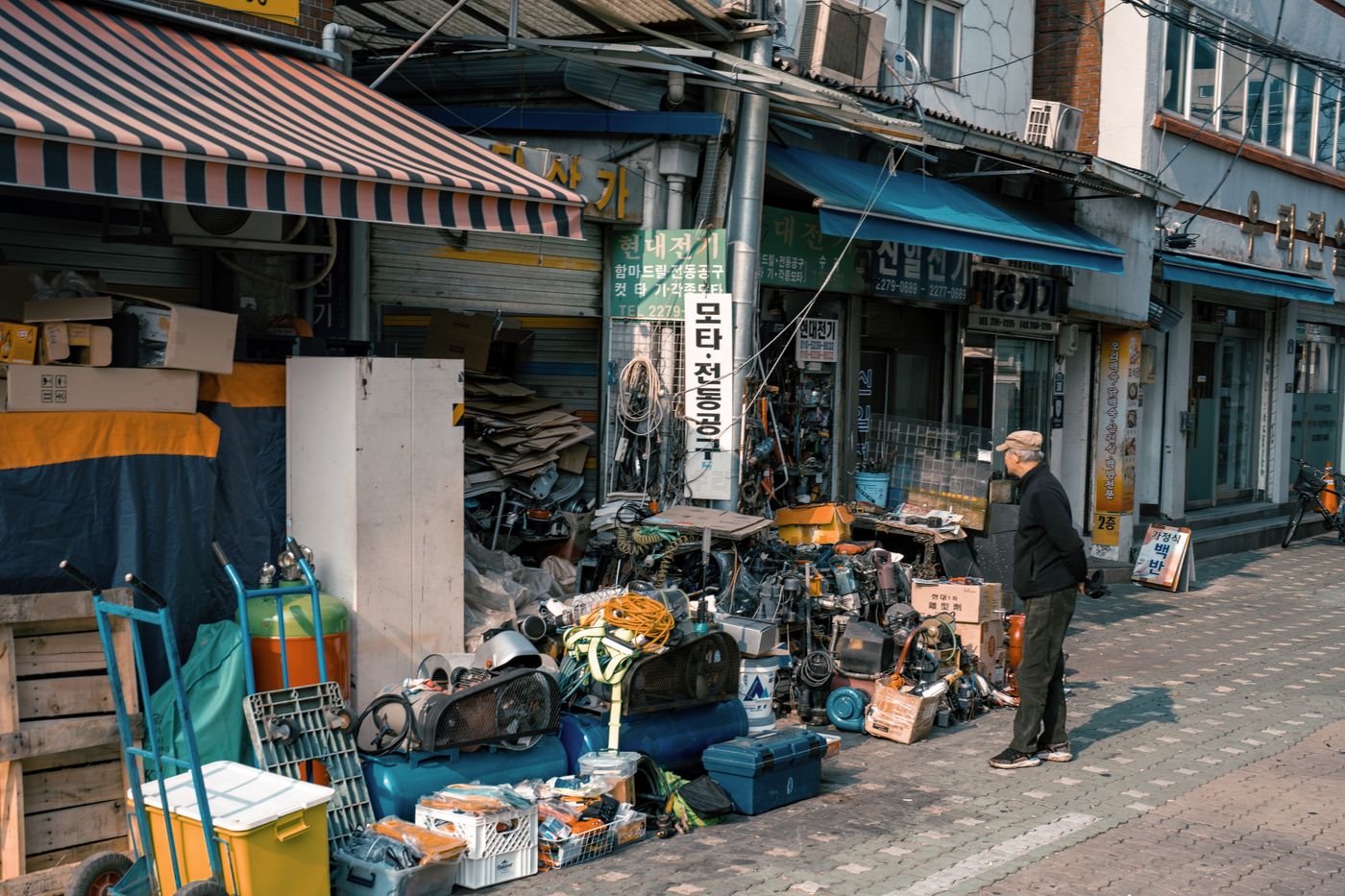 A busy Seoul shopfront with goods and street energy, showing the neighborhood context around craft and souvenir walks.