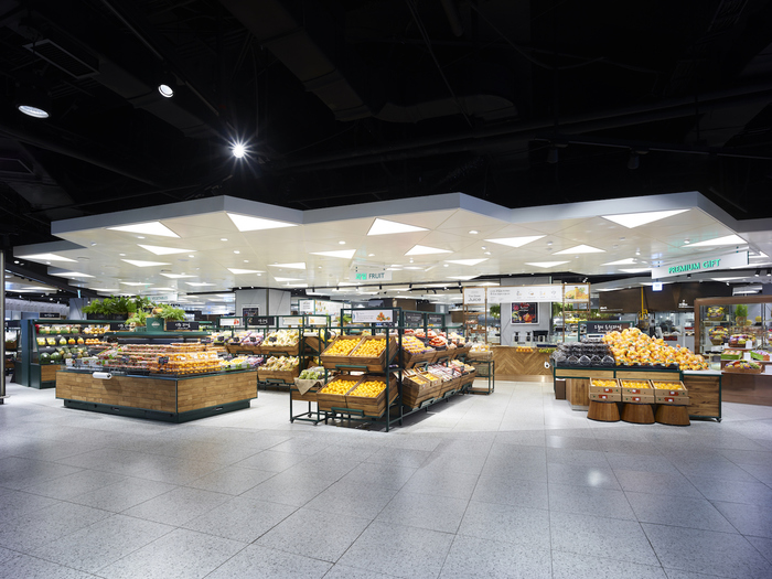 A Lotte Food Avenue grocery and fruit zone with bright indoor counters and premium produce displays.