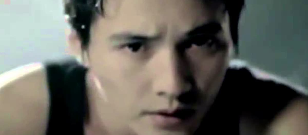 A close-up crop from a CJ ENM clip, showing the severe transformed look associated with Won Bin in Ajeossi.