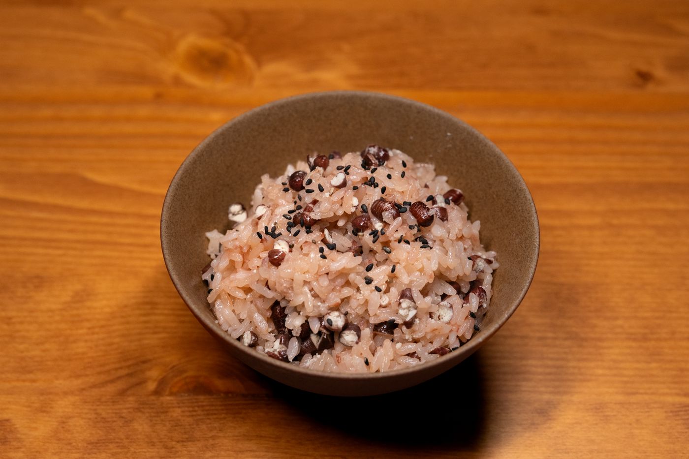 A bowl of mixed-grain sticky rice with beans and seeds.