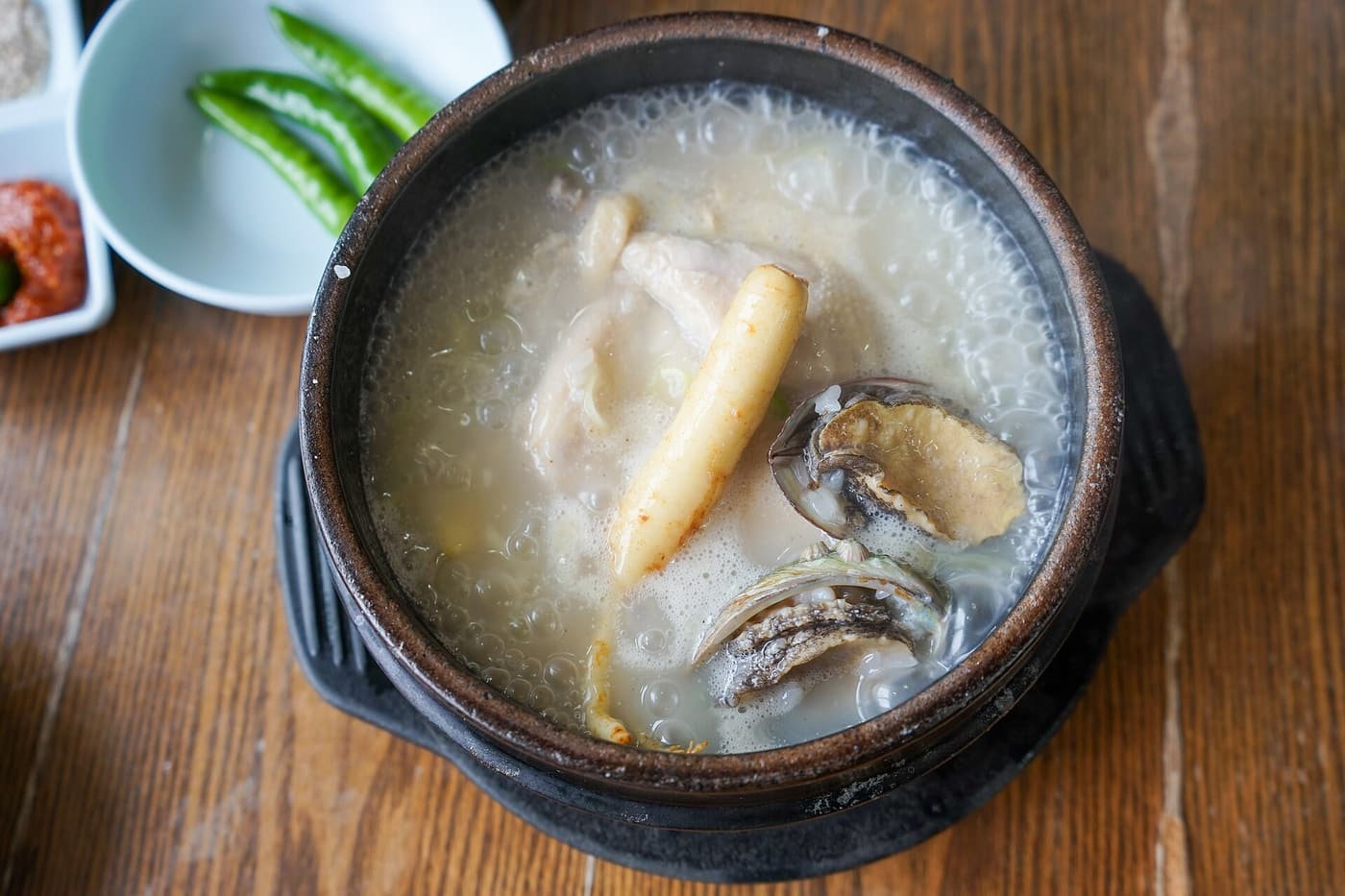 A Jeju-style samgyetang served with abalone alongside the chicken.