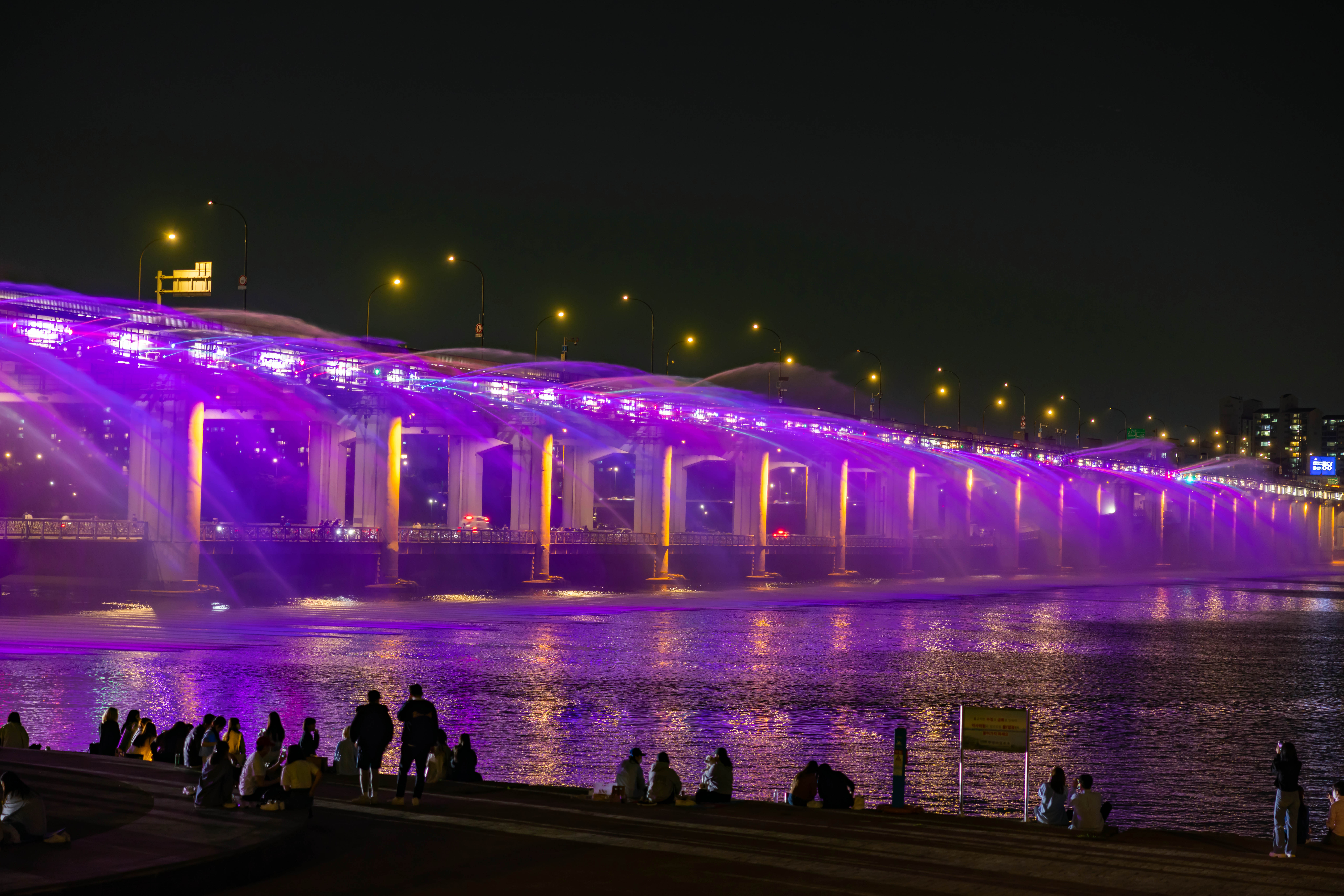 Banpo Bridge Moonlight Rainbow Fountain glowing at night over the Han River.