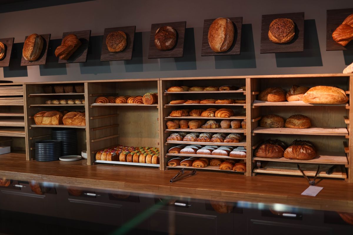 Fresh bread and pastries displayed inside a cozy artisan bakery.