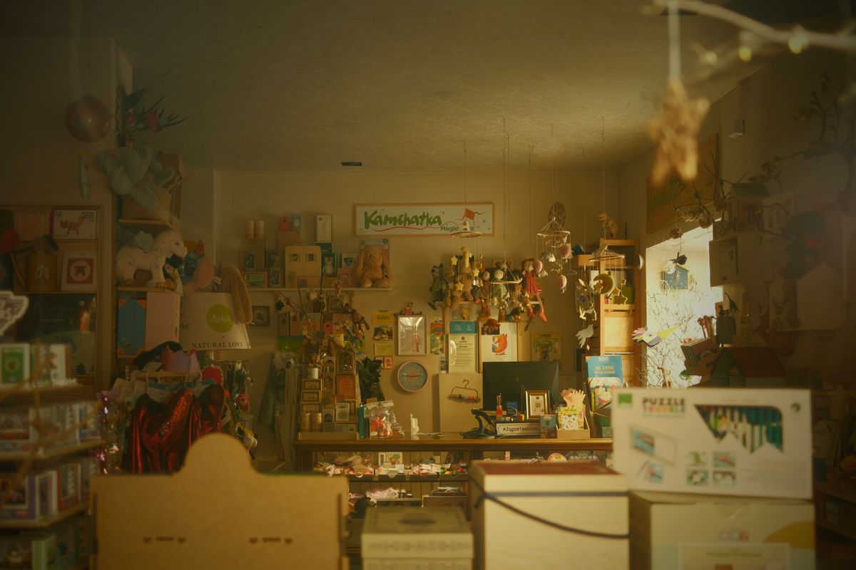 A toy-store shelf filled with colorful plush characters and giftable small goods.