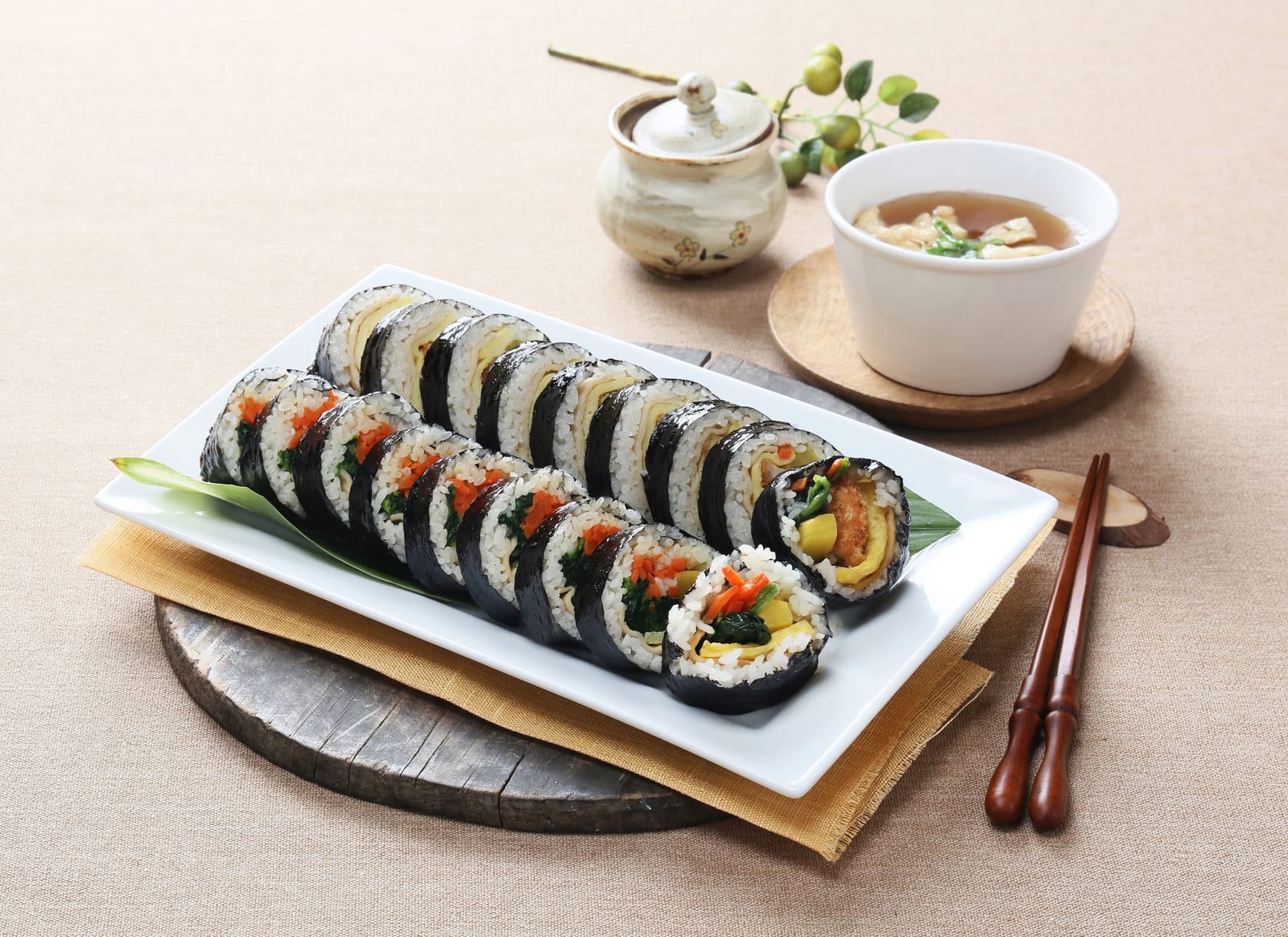 Freshly sliced gimbap rolls wrapped in gim, showing why rolling sheets are different from small snack packs.