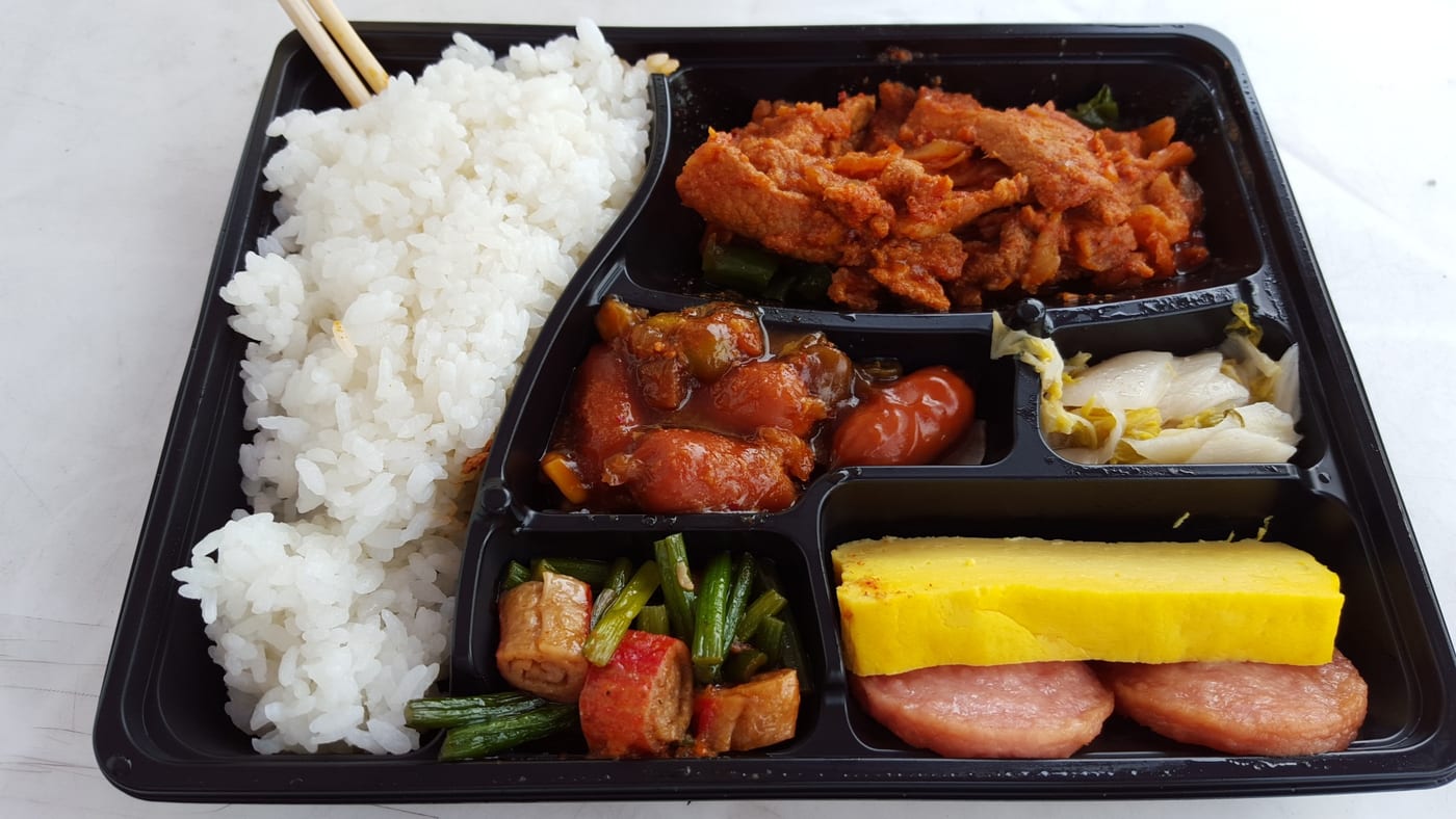 A convenience-store Korean dosirak with rice and multiple side compartments.