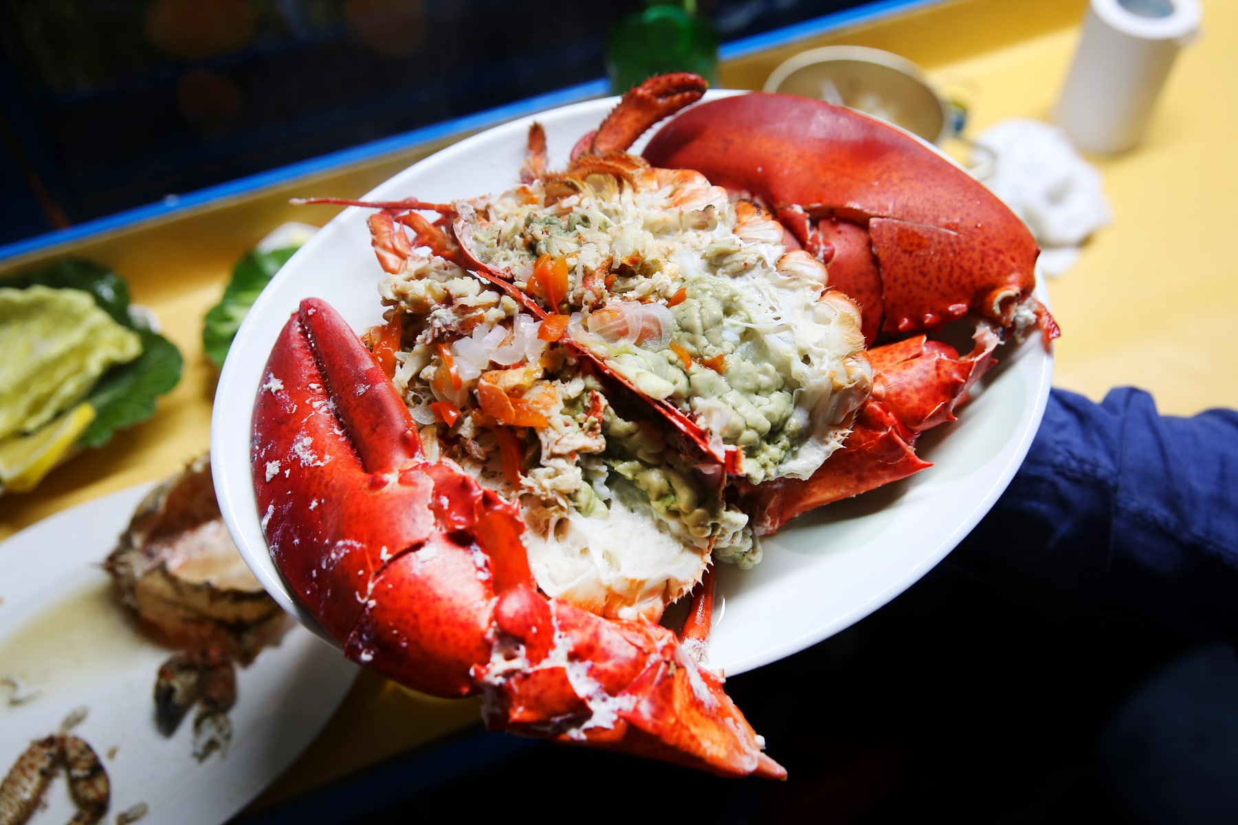 A large steamed lobster plated at a Haeundae pojangmacha seafood operation.
