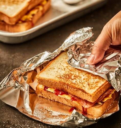 A Korean gilgeori-style toast sandwich wrapped for eating on the go.
