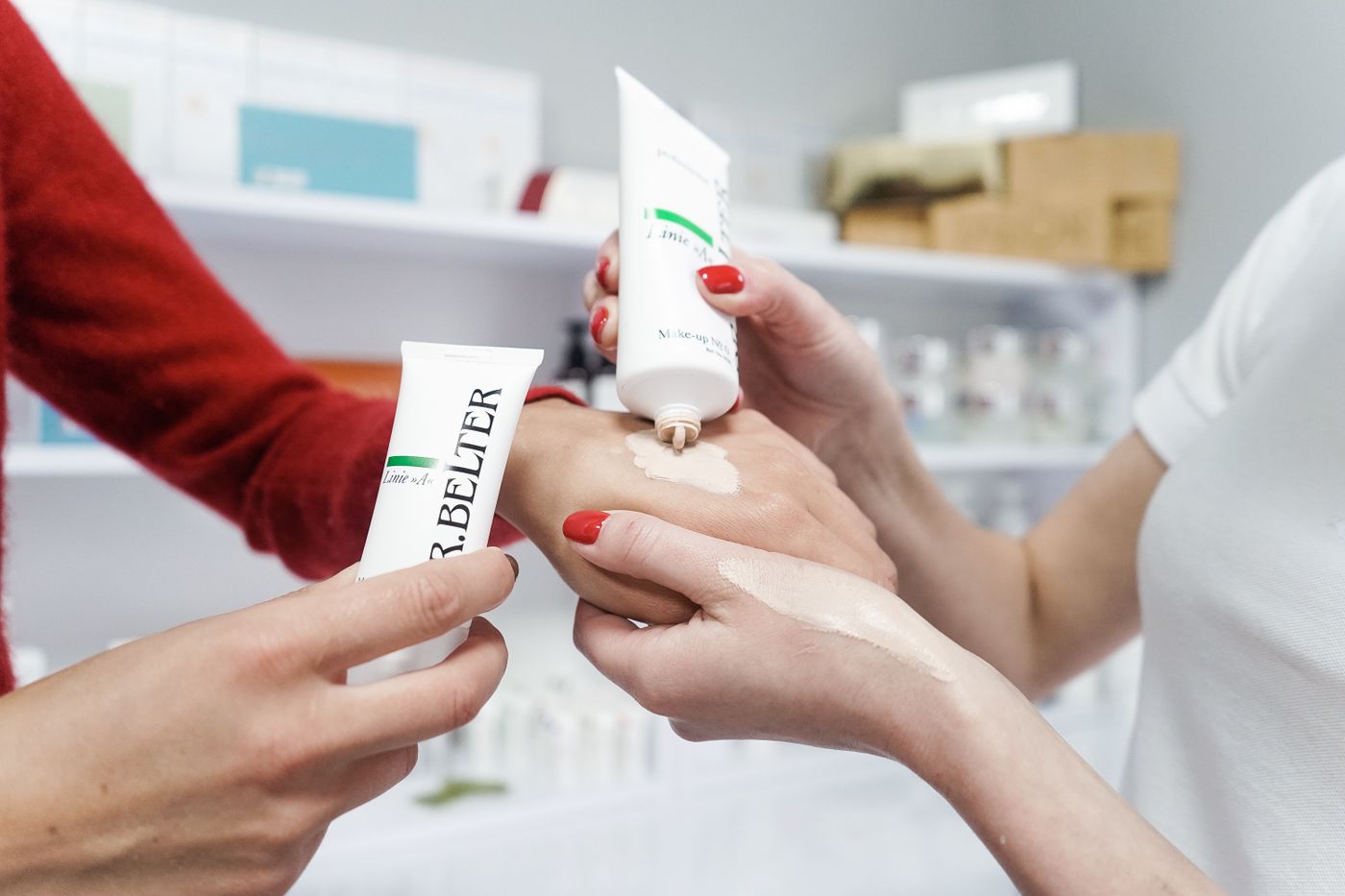 Hands comparing the texture of a cream before adding it to a routine.