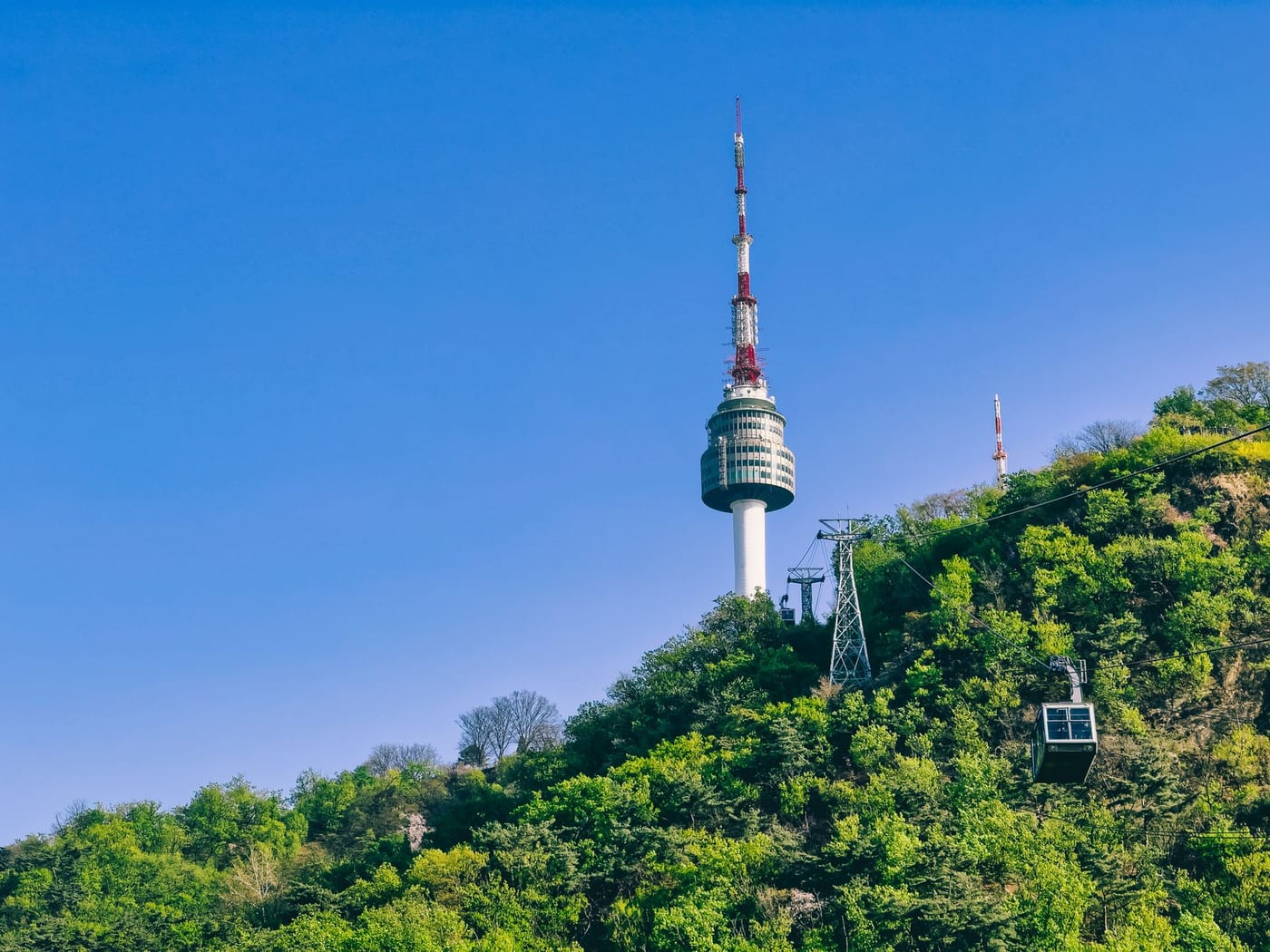 A Namsan cable car car moving up the hillside toward N Seoul Tower.