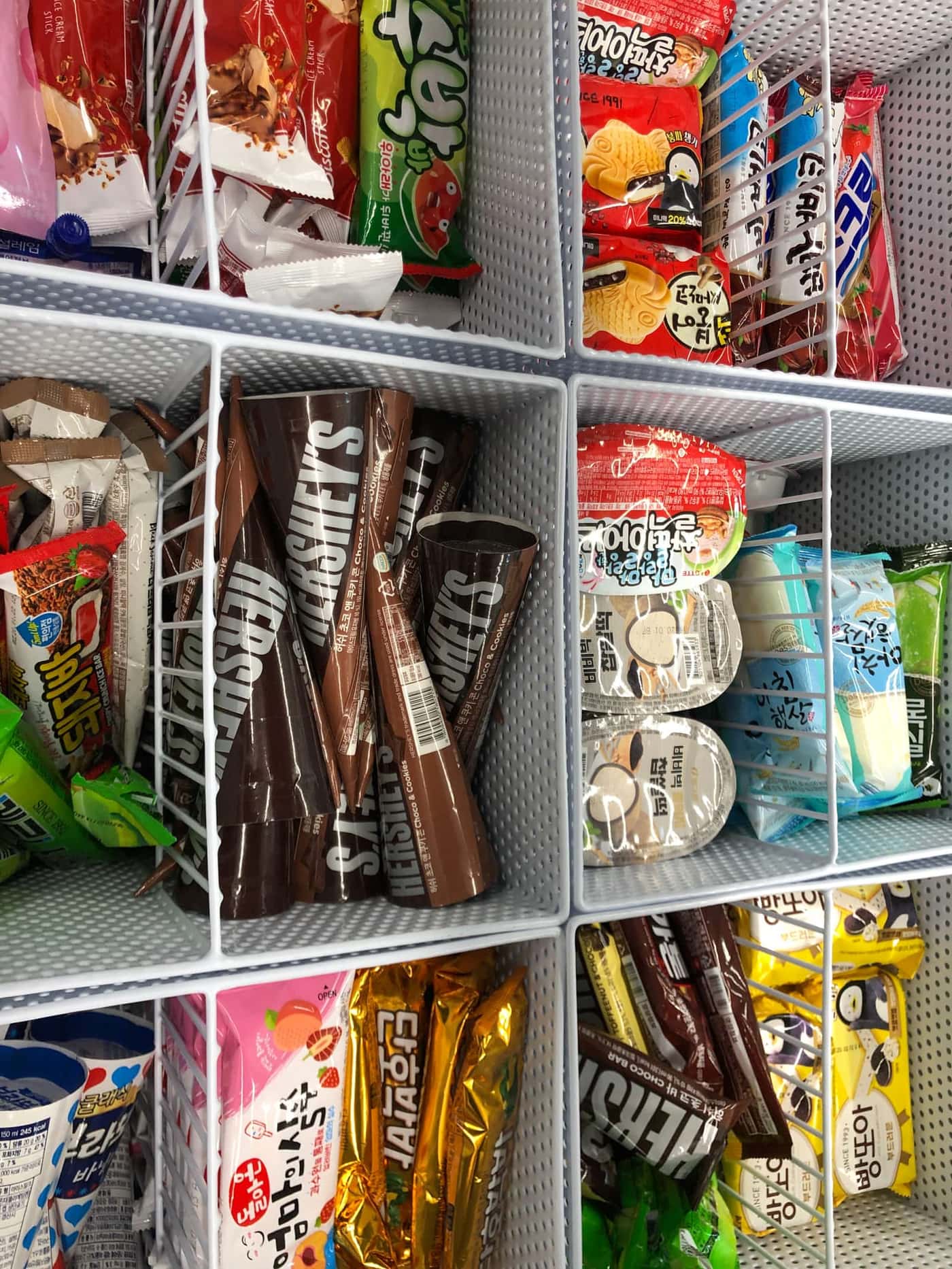 The frozen snack section inside a real CU convenience store in South Korea, showing a Watermelon Bar and other packaged treats.