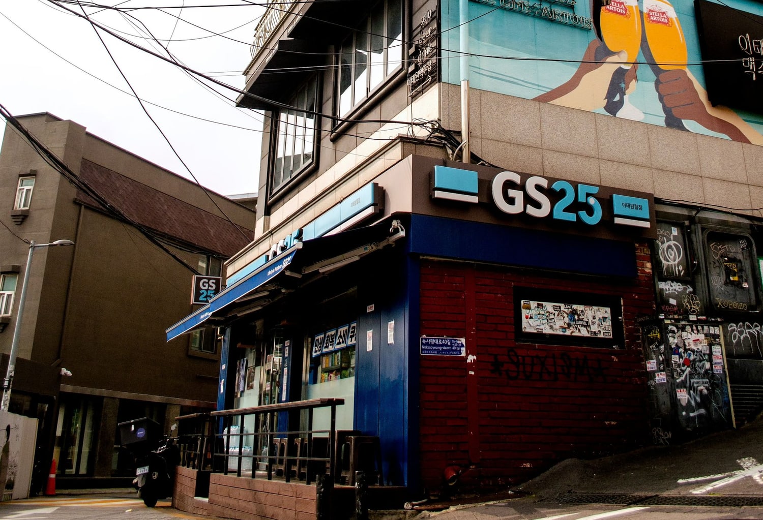 A GS25 convenience store on a street corner in Itaewon, Seoul, with Korean signage.