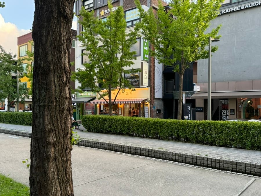 Low-rise shopfronts and small cafes on a Yeonnam-dong street.