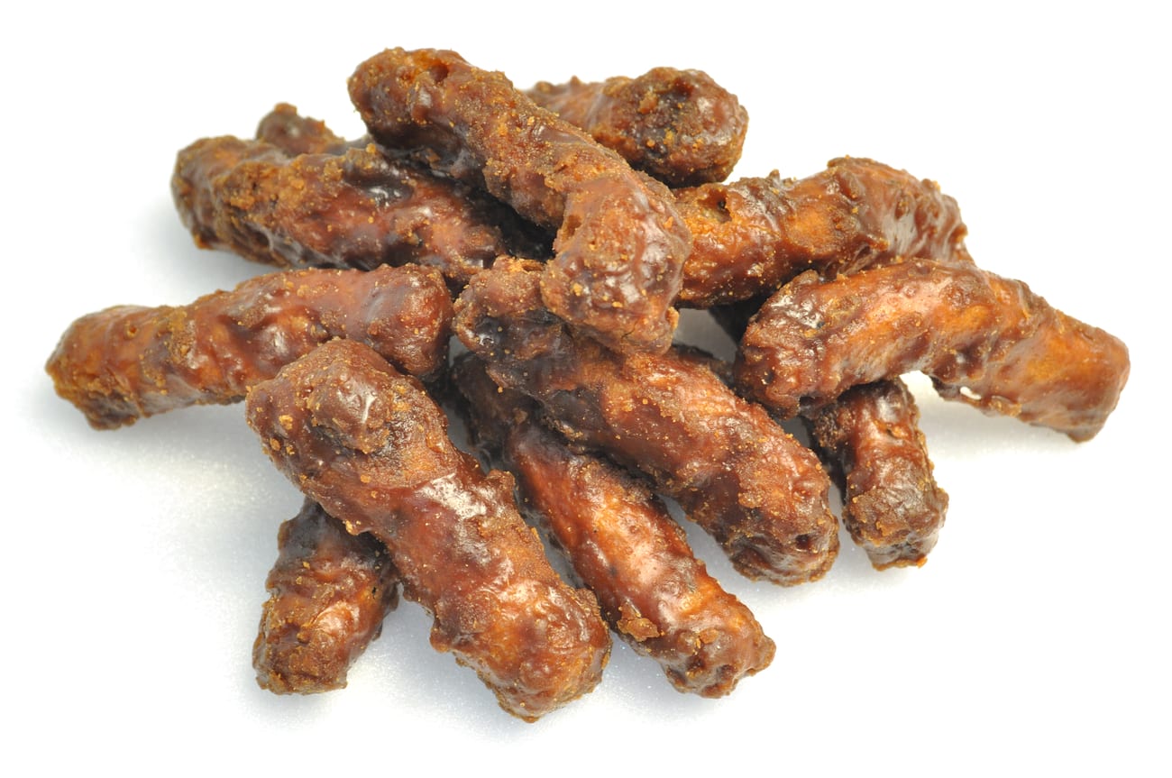 A pile of Japanese karinto — dark brown fried dough sticks with a bare sugar glaze.
