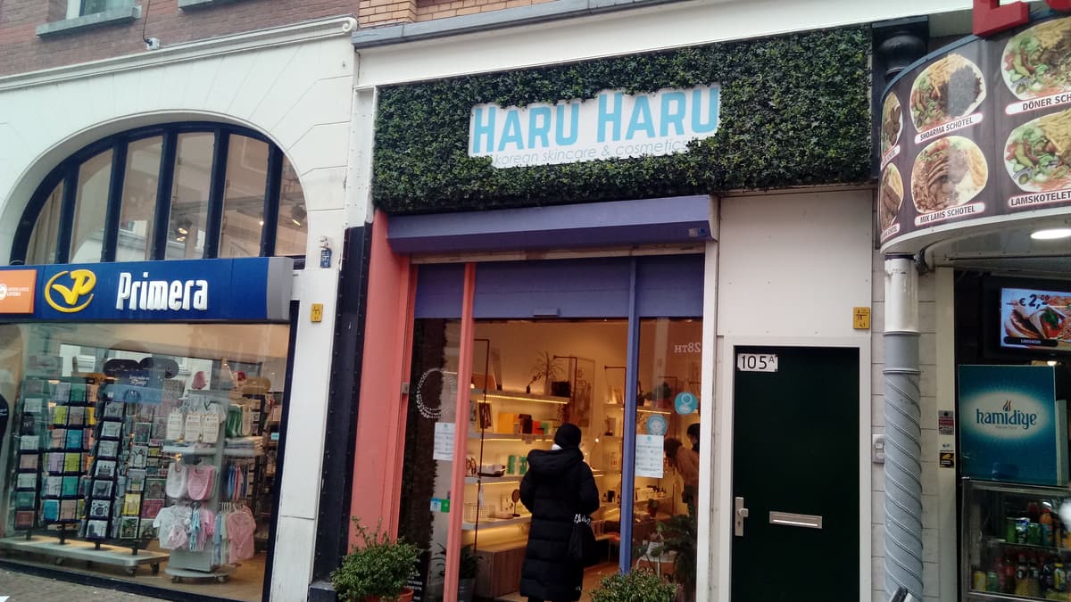 A Korean skincare and cosmetics shop called HARU HARU on a street in Rotterdam, its window marked Korean skincare & cosmetics.