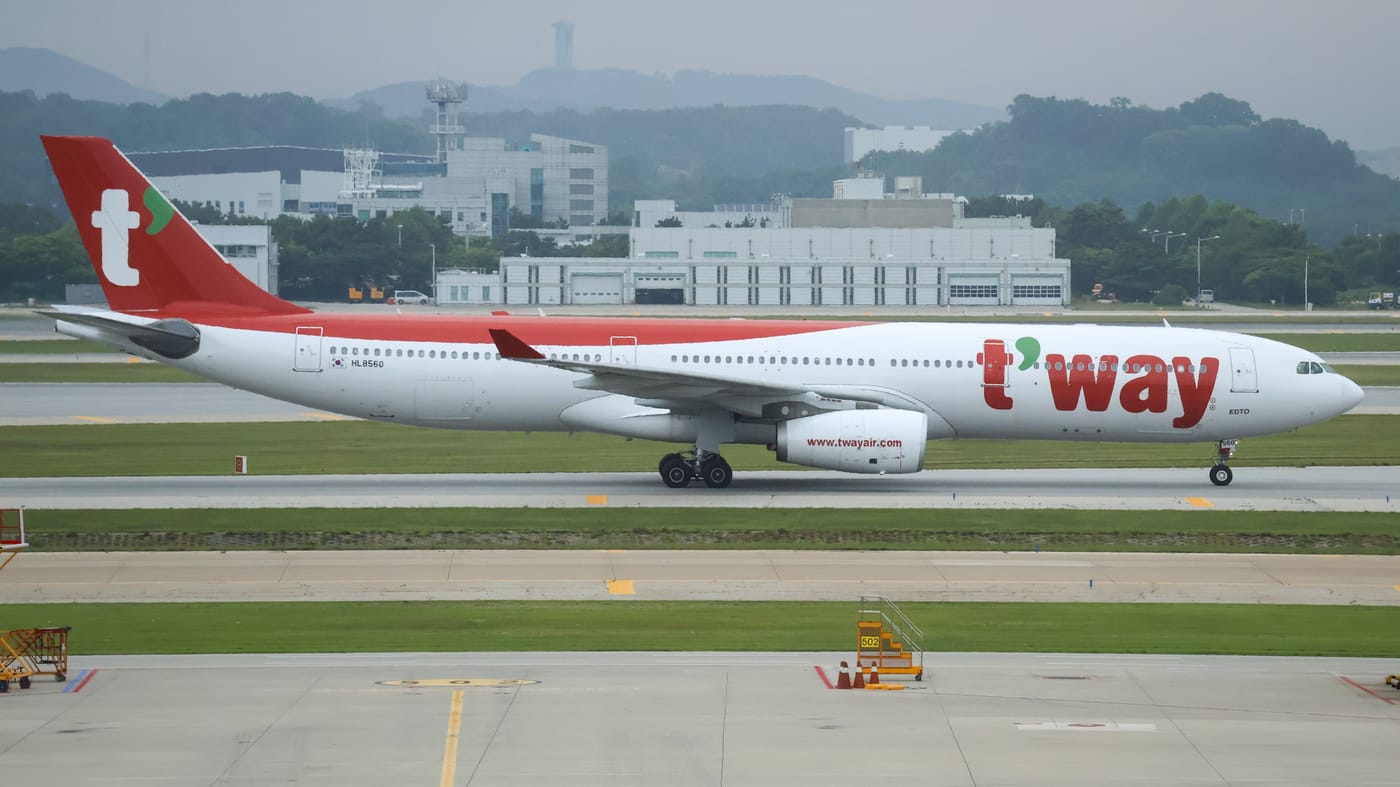 A T'way Air Airbus A330 taxiing at Incheon Airport in June 2026, white fuselage with the green-and-red t'way wordmark and a red tail stripe.