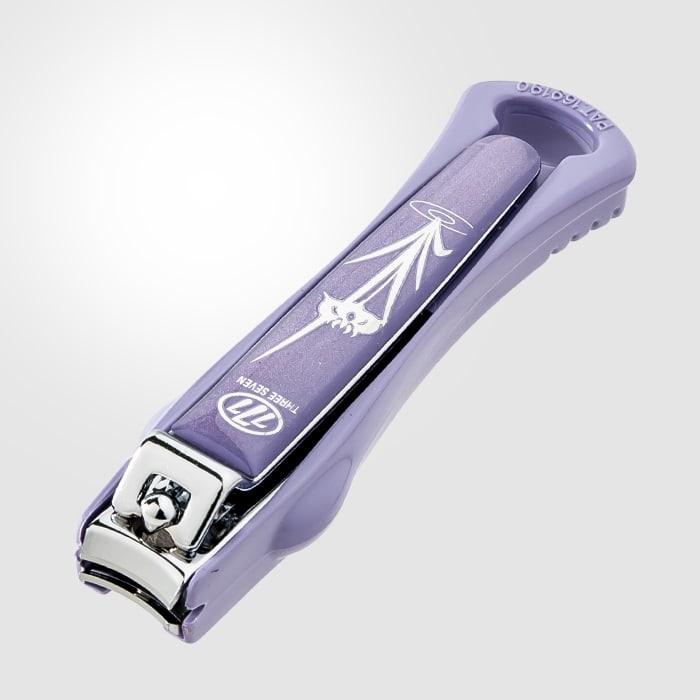 A Three Seven nail clipper in lavender, photographed at an angle so the 777 logo and the words THREE SEVEN stamped into the lever are readable.