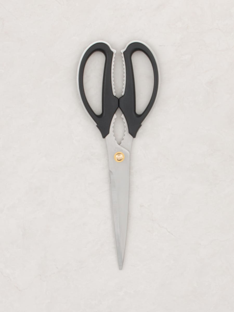 Product photograph of a Daiso large kitchen scissor: grey stainless blades, black rubber-lined rings and gripper teeth between the handles.