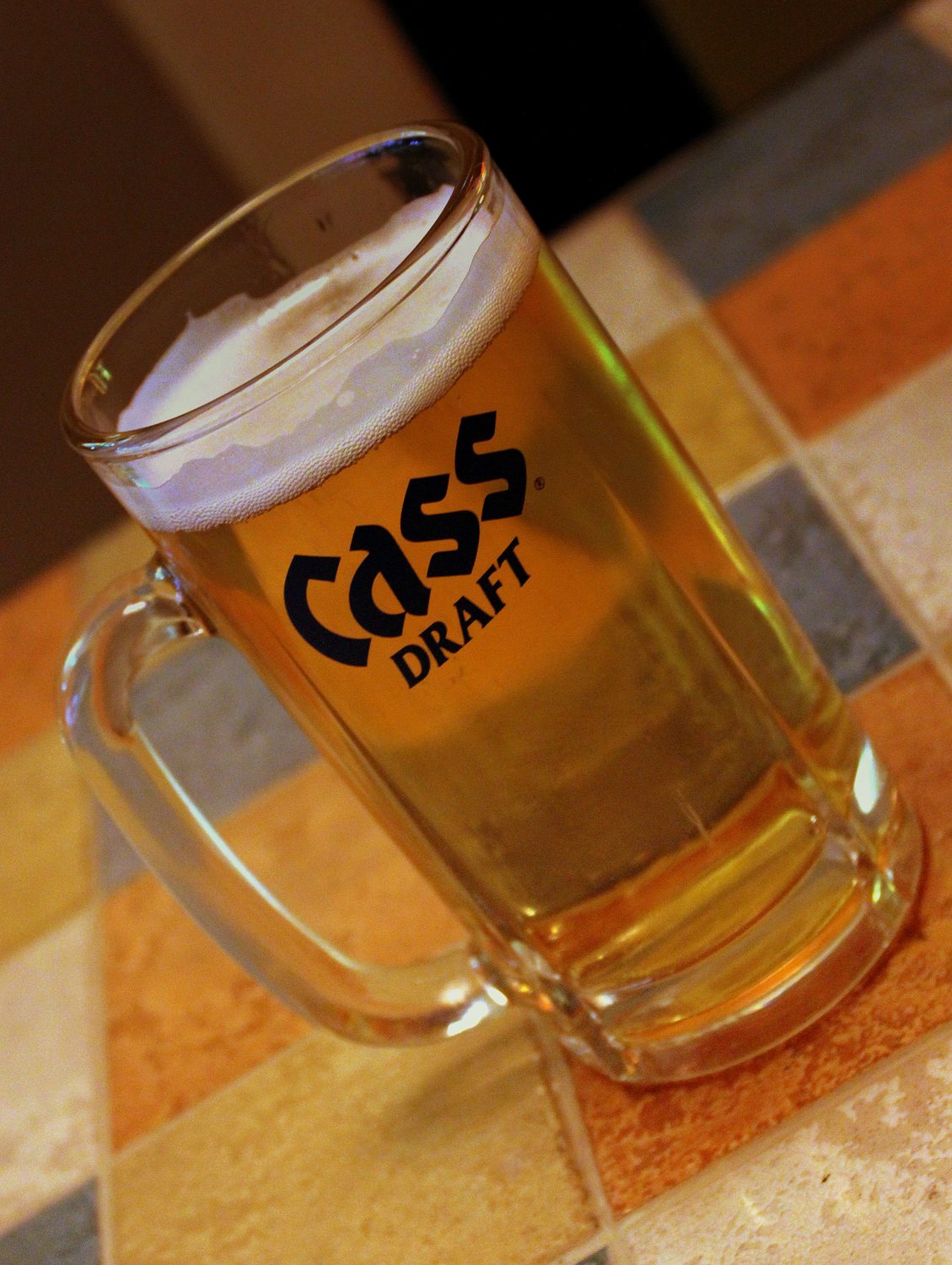 A frosted Cass Draft mug on a tiled counter in a Seoul bar, 2012.