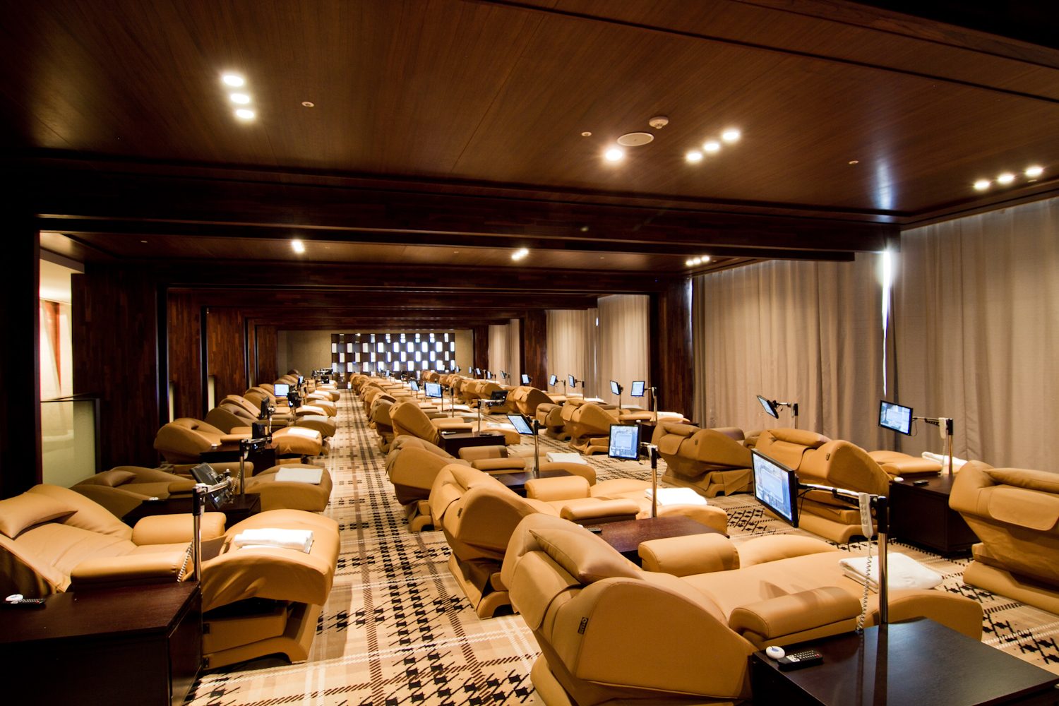 The relaxation room of The Riverside Hotel's Medi Spa: rows of reclining leather chairs, each with its own screen.