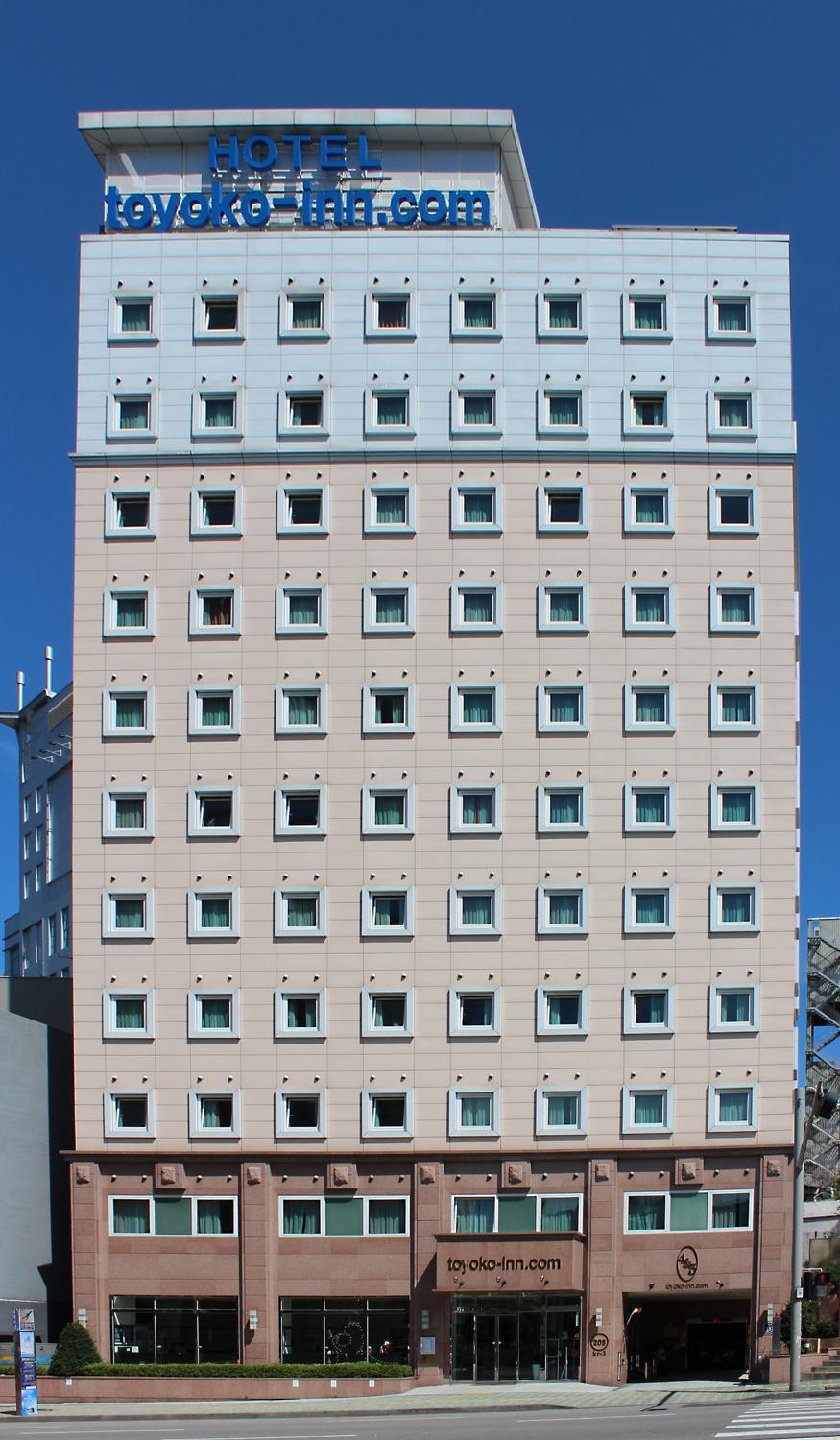 Toyoko Inn Seoul Dongdaemun, a mid-rise business hotel with rows of small identical windows and the chain's blue sign on the roof.