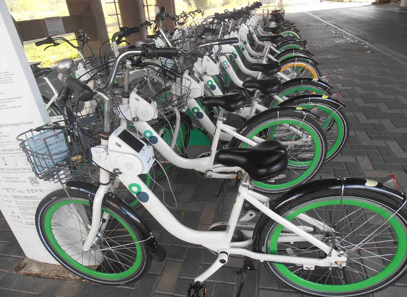 A row of Ttareungi bikes docked at a station on the Han River bikeway in Seoul.