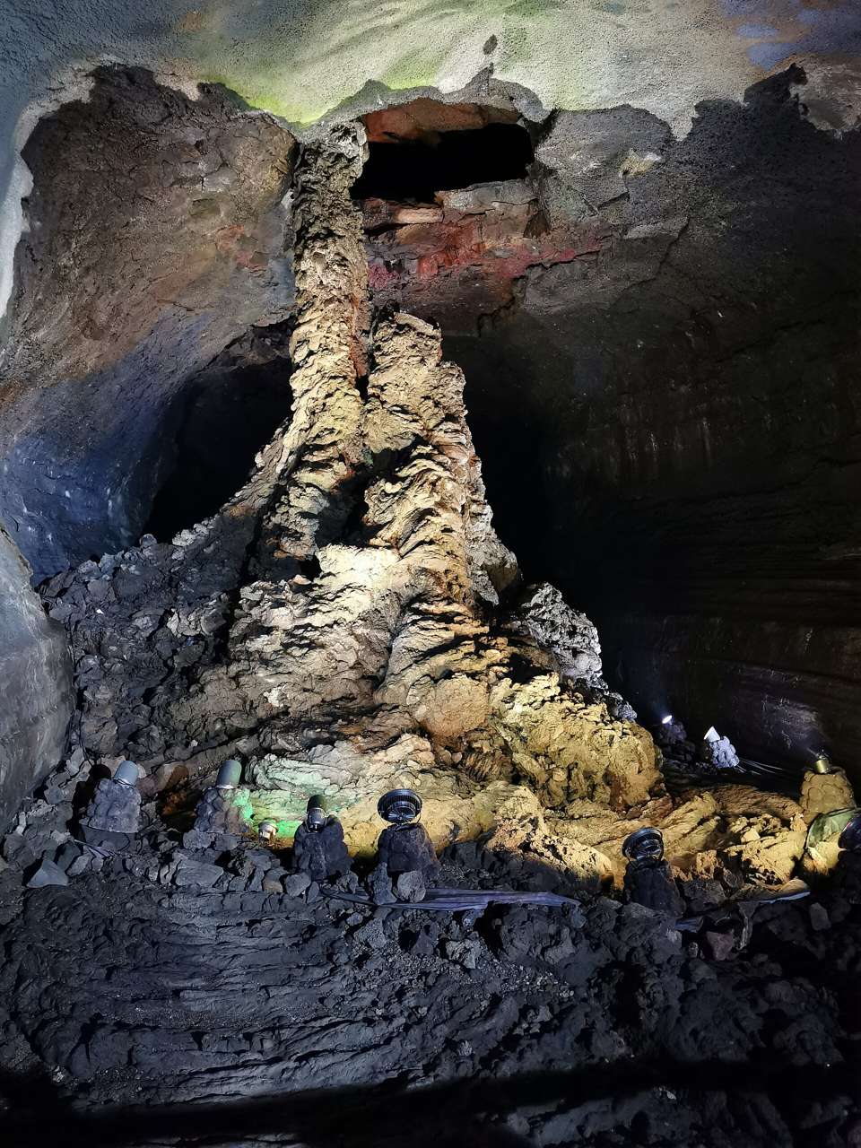 The lava column at the end of Manjanggul's public section, a tall ridged column of rock lit from below.