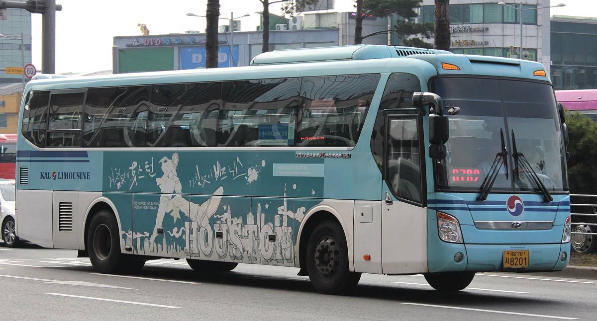 A KAL Limousine airport coach in pale blue livery on a Seoul road, its route display lit behind the windscreen.